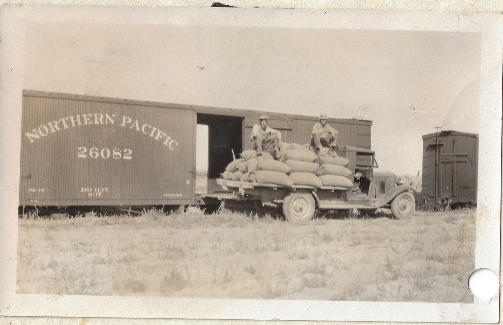 Judy Gaussoin loading wheat, around 1930